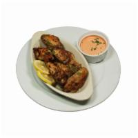 Classic Chicken Wings · Crispy bone-in chicken wings tossed in your choice of sauce. Served with a spicy red pepper ...