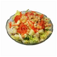 Tossed Green Salad · Iceberg lettuce, red cabbage, wedged tomatoes, cucumbers, shredded carrots, and garbanzo bea...