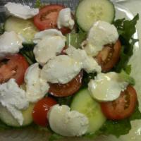 Caprese Salad · Made of sliced fresh mozzarella, tomatoes, sweet basil, seasoned with salt and olive oil.
