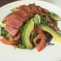 Seared Cajun Ahi Salad · Entrée salad. Sliced Cajun seared ahi, avocado, sliced tomatoes, and mixed greens with our h...