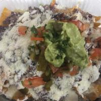 Beef Nachos · Fried tortillas chips topped with beans, melted cheese, beef, tomato, onion, jalapeños, sour...