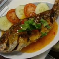 Pla Rad Prik · Hot and spicy. Deep-fried whole fish topped with three-flavored spicy sauce. Served with jas...