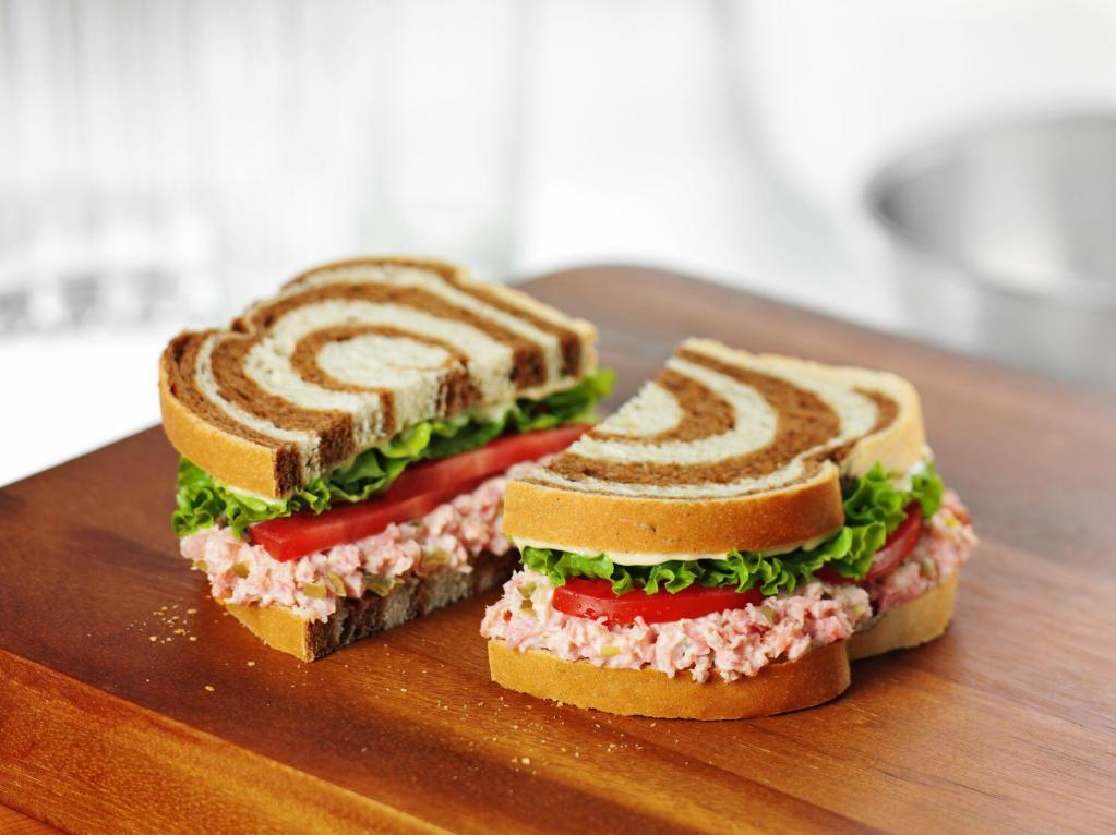 Ham Salad Sandwich · Honey Baked Ham Salad topped with lettuce, tomato & Duke’s Mayo on multigrain bread.