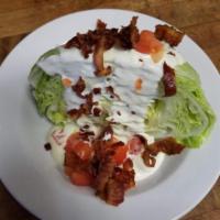 Iceburg Blue Cheese Tomato Wedge Salad · iceberg lettuce served with chopped tomato bacon crumbles and blue cheese