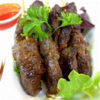 Beef Satay · Thai-style grilled marinated beef served with peanut sauce and sweet chili sauce. 