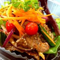 Tiger Tear Salad · Grilled beef with spicy Thai sauce, onions, scallions, tomatoes and ground roasted rice. Spi...