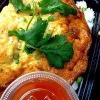 Thai Omelette · A thai-style omelette with minced chicken, basil leaves, onions and scallion served over the...