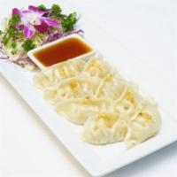 Dumpling · Steamed chicken dumplings served with a special soy sauce.