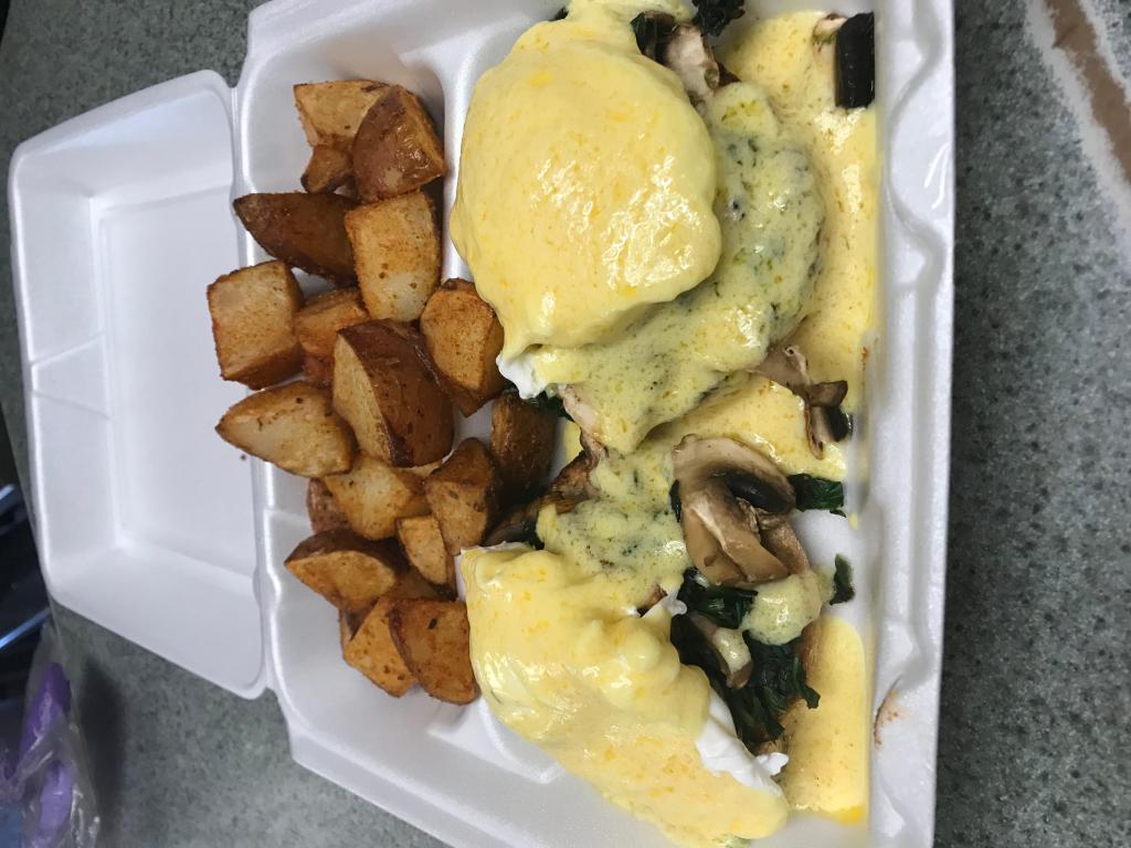 Spinach and Mushroom Benedict · 2 poached eggs, spinach, and mushroom on an english muffin. Served with home fries and creamy homemade Hollandaise sauce.