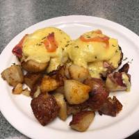 Salmon Benedict · 2 poached eggs and smoked salmon on an English muffin. Served with home fries and creamy hom...