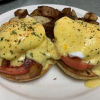 Eggs Blackstone · 2 poached eggs, bacon and tomato on an English muffin. Served with home fries and creamy hom...