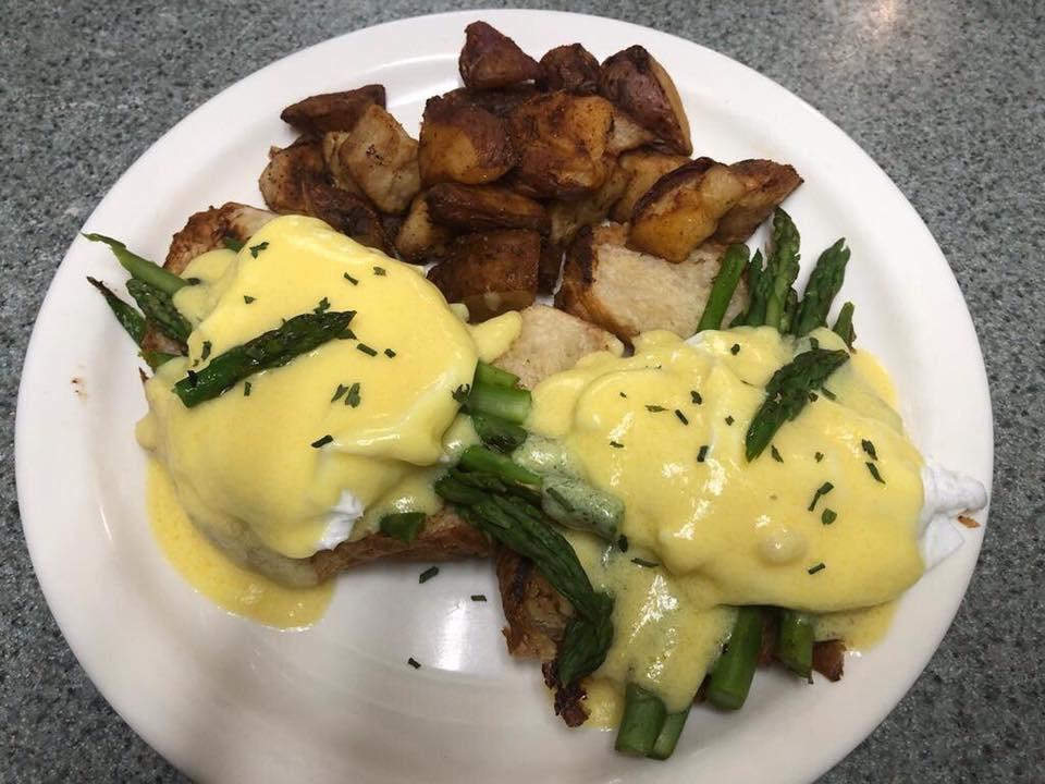 Easy Eggs Benedict with Asparagus · Over easy fried eggs, grilled Asoaragus, on a croissant, topped with homemade hollandaise sauce. Served with home fries.