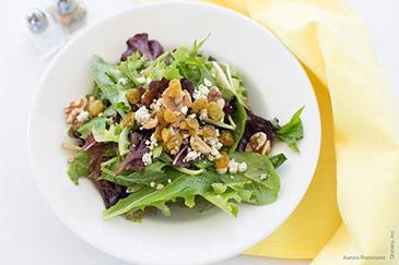 Arugula Salad · Organic arugula with feta cheese, walnuts, and golden beets in a housemade citrus dressing