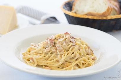 Spaghetti Alla Carbonara · Served with pancetta, creamy egg yolk in Parmigiano sauce.