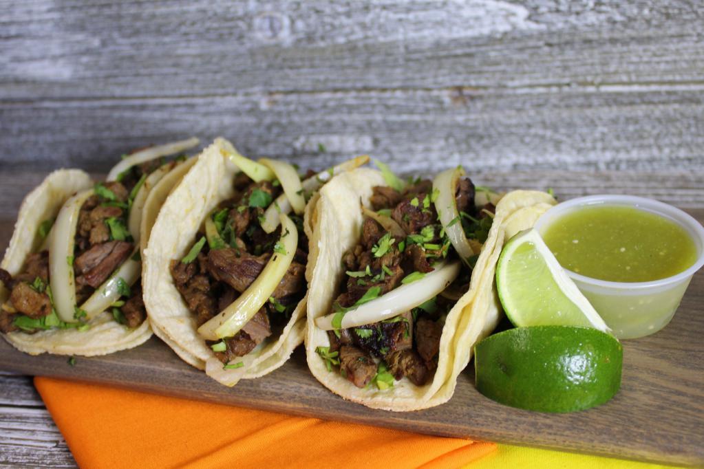 Tacos · Served with onions, cilantro and hot sauce.