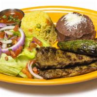 Carne a La Parrilla · Grilled beef. Served with rice, beans, salad and tortillas.