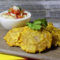 Tostones · Green fried plantains.
