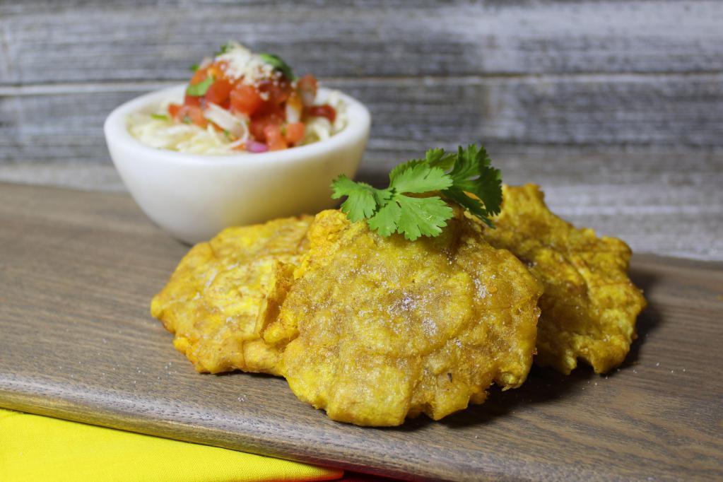 Tostones · Green fried plantains.