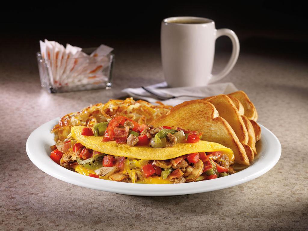 Ultimate Omelette® · Three-egg omelette with sausage, bacon, fire-roasted bell peppers & onions, sautéed mushrooms, tomatoes and Cheddar cheese. Served with hash browns and bread.