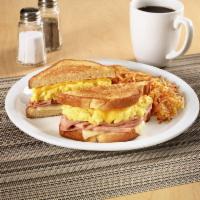 Moons Over My Hammy® · Ham and scrambled egg sandwich with Swiss & American cheeses on grilled sourdough. Served wi...
