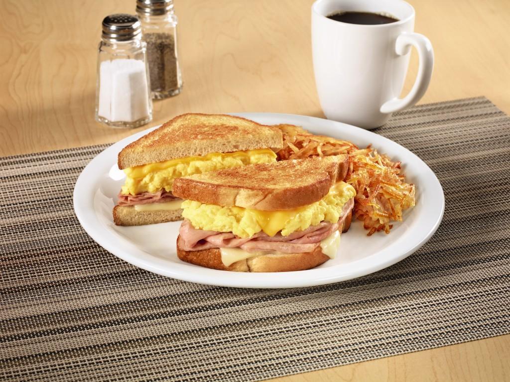 Moons Over My Hammy® · Ham and scrambled egg sandwich with Swiss & American cheeses on grilled sourdough. Served with hash browns.