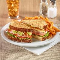 Cali Club Sandwich · Turkey breast, ham, crisp bacon, Swiss cheese, and fresh avocado on toasted 7-grain bread wi...
