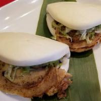 2 Pieces Chashu Bun · Steamed bun served with chashu, shredded lettuce, scallions over house sauce.