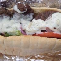 Kofte Sandwich · Spiced and grilled ground beef and lamb, lettuce, tomato and red onion. Served on pita with ...