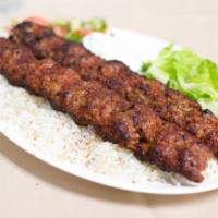 Adana Kebab · Marinated ground lamb, skewered and grilled. Served with rice and grilled tomato, onion and ...