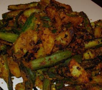 Bhindi Masala · Fresh okra sauteed with onions, green peppers and tomatoes in an exotic spice blend. Vegetarian.