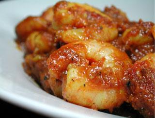 Shrimp Vindaloo · Shrimp and potatoes cooked in a flery hot curry sauce. Served with rice.