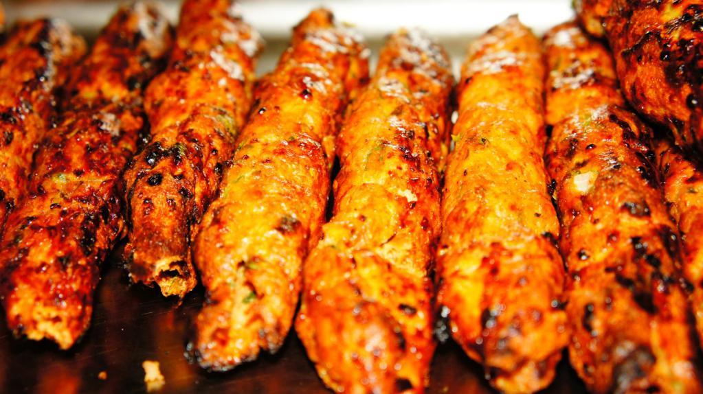 Chicken Seekh Kabab Roll · Seasoned long chicken kababs grilled to perfection on our charcoal skewer in the Tandoor ( clay oven ) . Then tossed between a warm paratha bread with onions, cilantro, hand crafted tamarind chutney and wrapped to go.