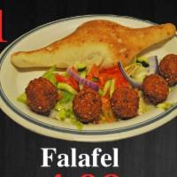 21. Falafel Sandwich · Ground chick peas mixed with peas mixed with parsley, deep fried wrapped in pita bread with ...