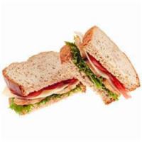 West Coast Turkey · Roasted turkey, provolone cheese, spring mix, sliced tomatoes, and pesto spread served on a ...