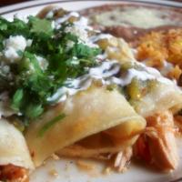 Enchiladas Verdes · 3 chicken enchiladas covered with green sauce, sour cream, Mexican cheese and cilantro, serv...