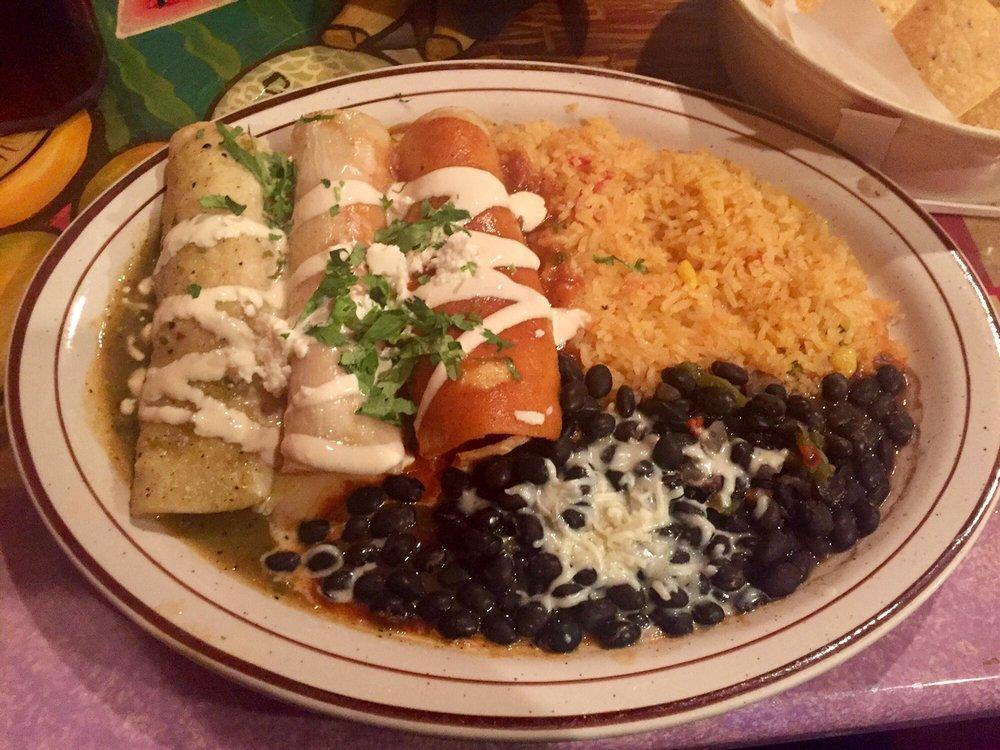 Enchiladas Banderita · 3 chicken enchiladas each covered with a different sauce. Queso, verde and our house enchilada sauce. Topped with sour cream, cilantro and Mexican queso fresco. Served with a side of rice and beans.