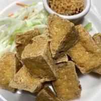 7. Fried Tofu · Golden fried fresh tofu with plum sauce and crushed peanut.