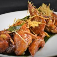 Peek Kai · Signature wing chicken wings marinated in fish sauce, deep fried, tossed in caramelized garl...