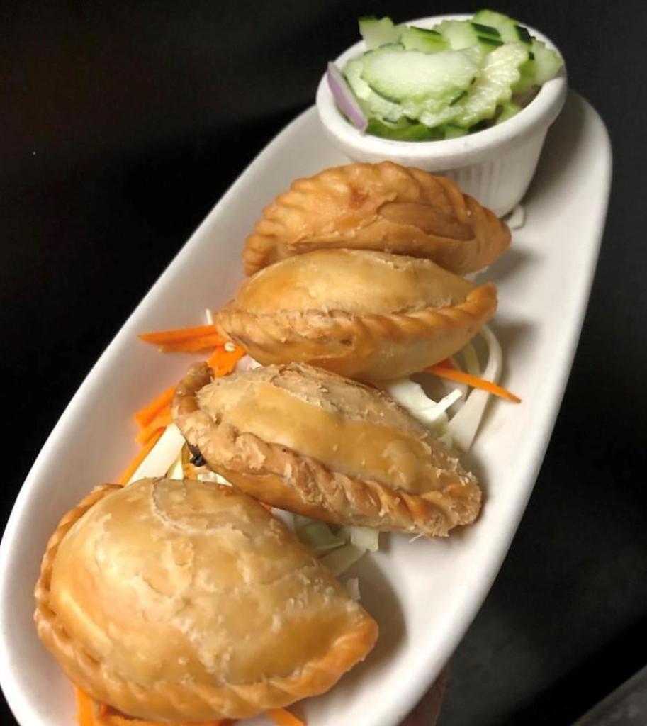 Karee Puff · Red potato, caramelized onion, carrot wrapped in pastry skin. Served with cucumber salad.