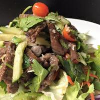 20. Beef Salad · Sliced grilled beef, flavored with spicy lime sauce and tossed with lettuce, tomatoes, mint,...