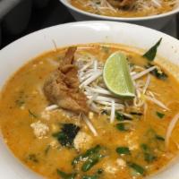 29. Tom Yom Noodle Soup · Rice noodles in spicy tom yum soup with minced chicken, bean sprouts and fresh basil topped ...