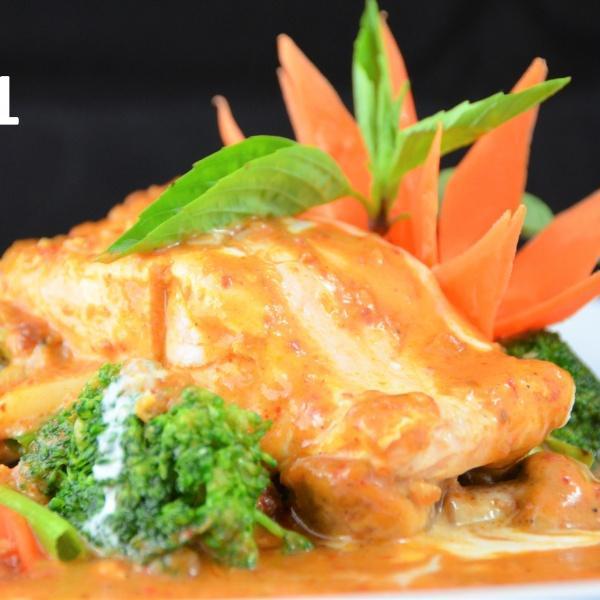 41. King Salmon Curry · Grilled salmon grilled to perfection, with a touch of smooth and homemade curry sauce on a bed of vegetables.