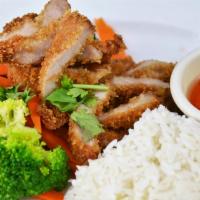 54. Khao Moo Tod · Golden fried marinated pork loin, steamed broccoli, and carrots over jasmine rice served wit...