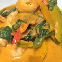 58. Asian Pumpkin Curry · Delicious red curry with black tiger shrimps, spinach, Thai pumpkin, bell pepper and sweet b...