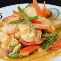 65. Panang Seafood · Sauteed black tiger prawns, green mussel, calamari, salmon, scallops, green beans, bell pepp...
