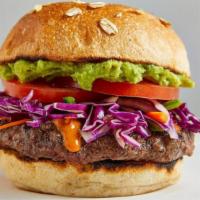 Guacamole Burger · Beef, tomato, spicy slaw, and chipotle puree. Served on an artisan bun.