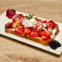 Dirty Fork Breakfast Special · French toast, baked egg in center, topped with fried chicken, fresh strawberries and syrup.