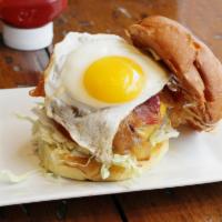 Breakfast Burger · Topped with hickory smoked bacon, cheddar cheese, sunny side up egg and homemade aioli. Serv...