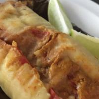 Tamales Guatemaltecos · Chicken or pork tamales served with a bread roll. 