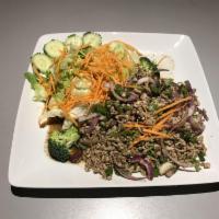 8/b. Larb Gai · Minced chicken with cilantro tossed in mild chili lime dressing. Served with lettuce, carrot...
